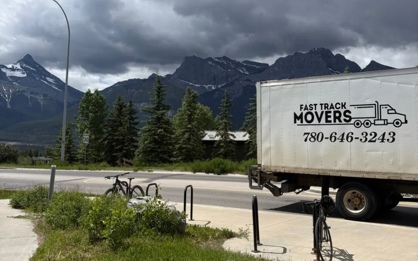 Fast Track Movers box truck parked with the Rocky Mountains behind it on a long distance move