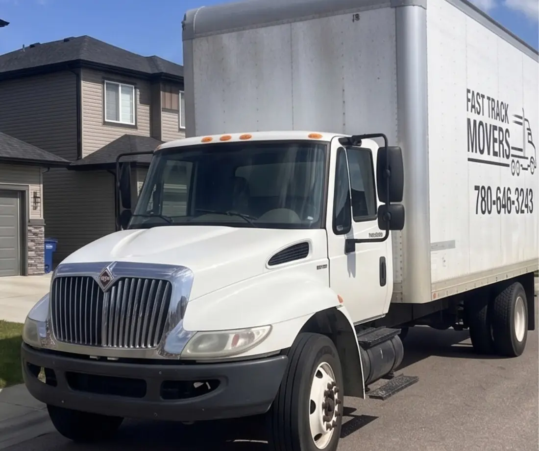 Fast Track Movers box truck parked in a residential driveway in the Lakeland